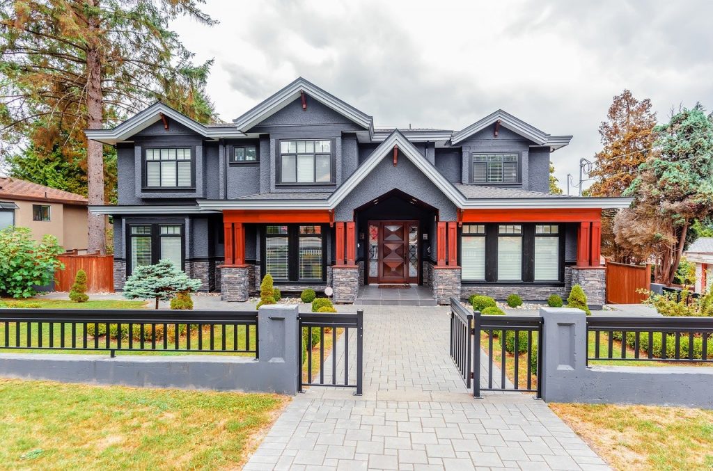 A gray house with metal fence