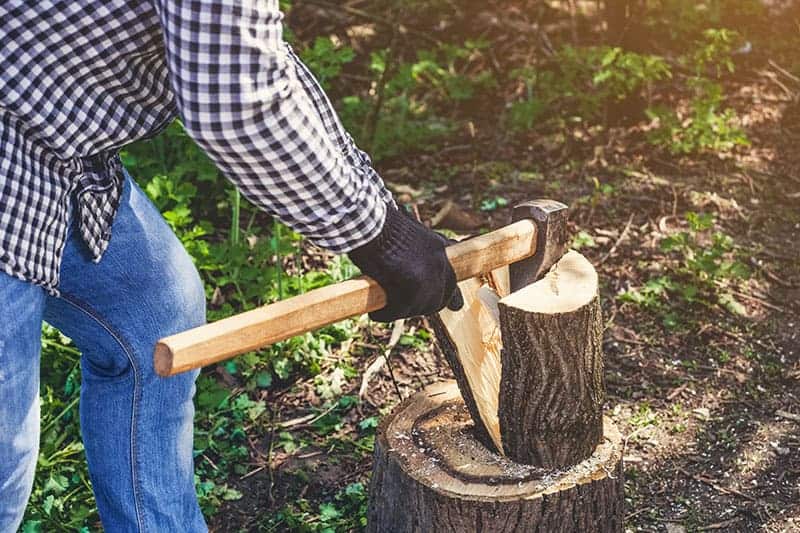 A Man Splits wood