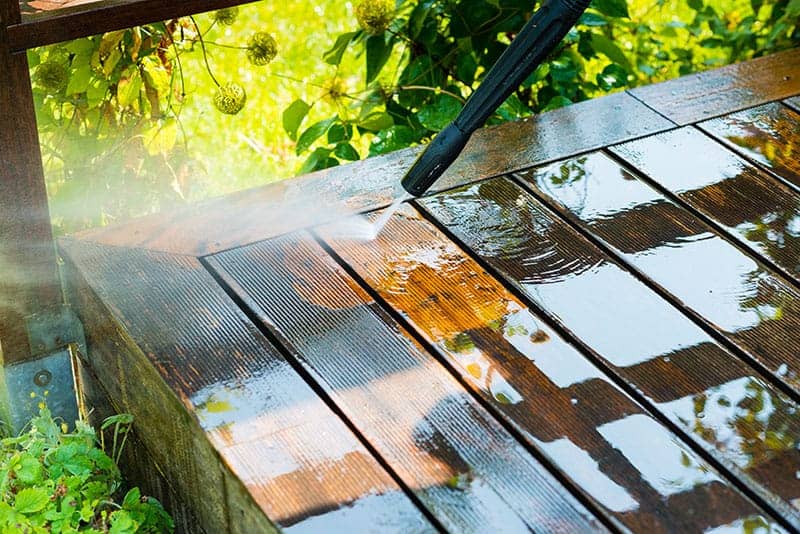 cleaning a deck with a power washer